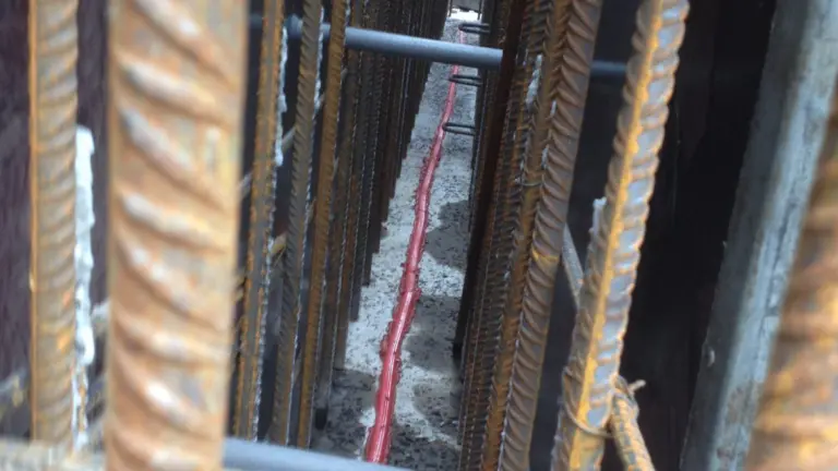 Inside of shuttered wall with water bar running through