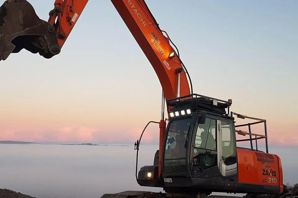 Hitachi 210 LC up above the clouds at windfarms