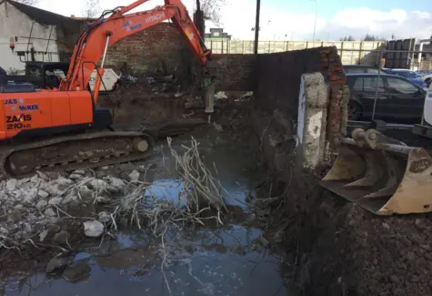 Breaking out previous buildings foundations JPG