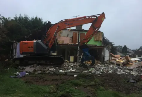 Demoliting existing buildings using grab on Excavator JPG