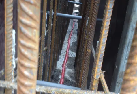 Inside of shuttered wall with water bar running through JPG