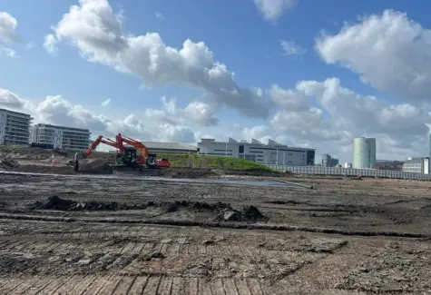 Stripping site and laying geogrid for mud mat