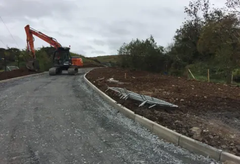 Levelling soil on side of roadway JPG
