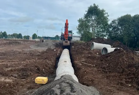Drainage pipes being laid and back filled