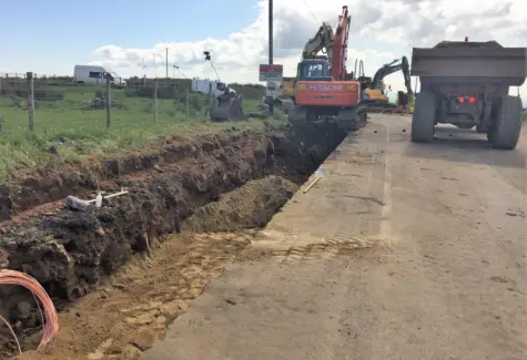Digging trench for powerline on road to windfarm JPG